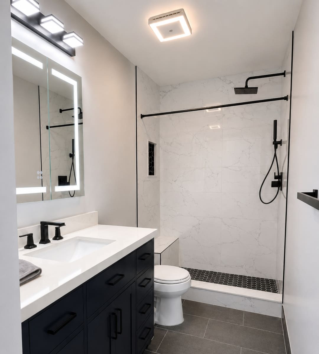 After: white walk-in shower with black fixtures and a navy vanity in Livonia